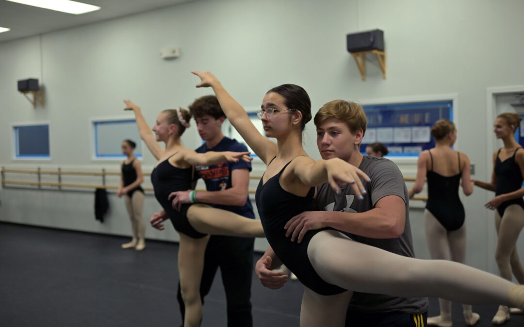 Students and volunteers work in pas de deux classes.